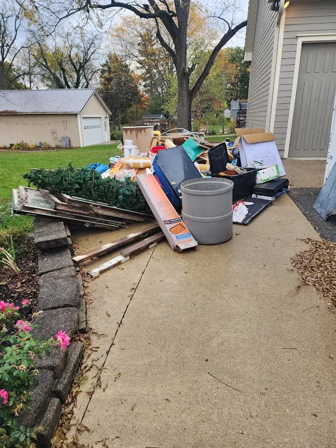 Dumpster being loaded with debris for Roofing Dumpster Rental in St. Johns
